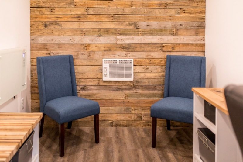 Photo provided by Brian Mininger Two side chairs in the tiny office, in front of an all-wood paneled wall.